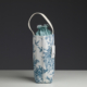 Un coussin XCOMM_COUSSIN 30X50 ESCARPOLETTE BLEU, orné d'un imprimé toile bleu, posé à la verticale sur une surface unie, devant un fond sombre. la marque Toile de Jouy